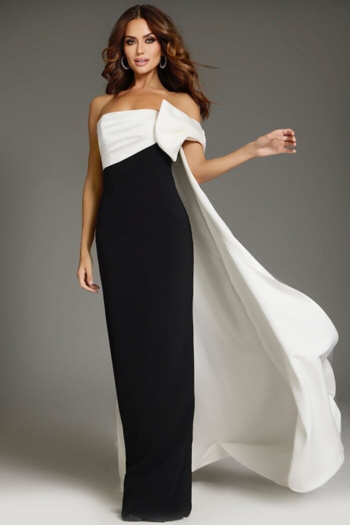 Model wearing Jovani 38864 elegant black and white gown with a draped shoulder