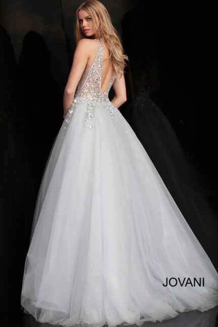 Model showcasing the back of Jovani 65379 white ballgown with low cut and beading.